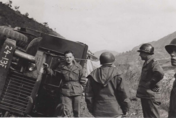 My grandfather's caption reads: Posing before my overturned ambulance, Nov. '51