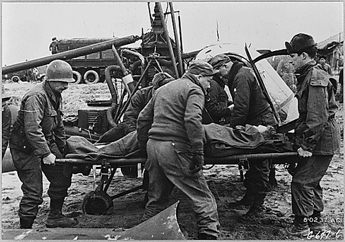 Medics helping wounded soldier during the Korean war.