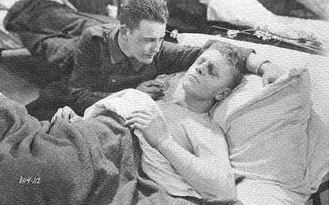 Paul tries to comfort his dying friend in All Quiet on the Western Front (1930).